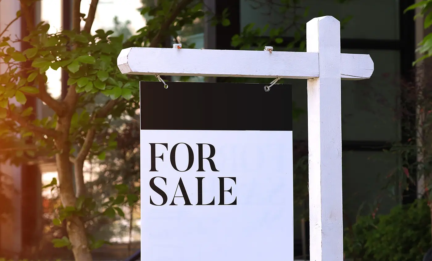 A modern for sale sign outside a home