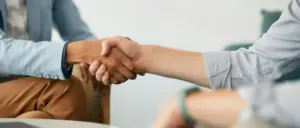 Two people shaking hands with each other